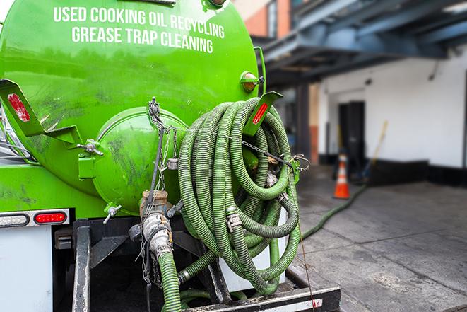 large truck pumping grease trap at a restaurant in Kennewick